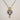 Hand-painted porcelain muse heart pendant necklace, close up of face motif and gold leaf crown