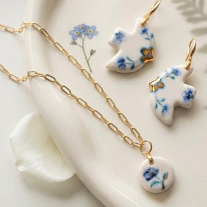 BitaJewells Delft blue floral porcelain dove earrings and round pendant necklace set with 22K gold lustre accents.