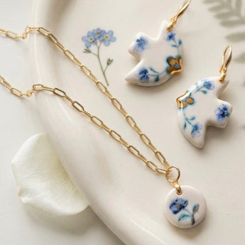 BitaJewells Delft blue floral porcelain dove earrings and round pendant necklace set with 22K gold lustre accents.