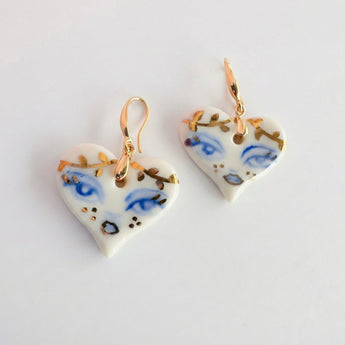 BitaJewells hand-painted white porcelain heart earrings with cobalt blue eyes and 22K gold accents. Hypoallergenic hooks.