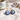 Celestial Gaze Porcelain Earrings alongside a cup of tea, highlighting these unique statement earrings with cobalt blue moon face design and gold accents.