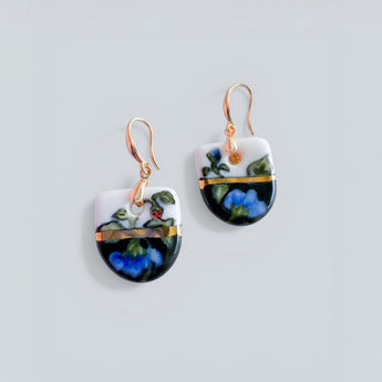 Pair of earrings with floral design on a light gray background