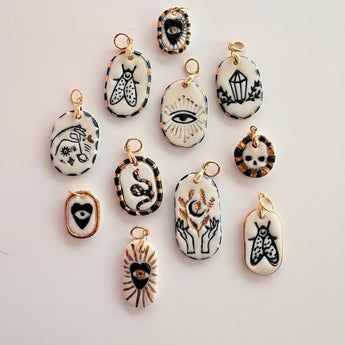 Handmade ceramic mystical charm pendant, black white and gold