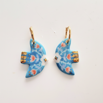 Clean product shot of turquoise dove earrings on white background