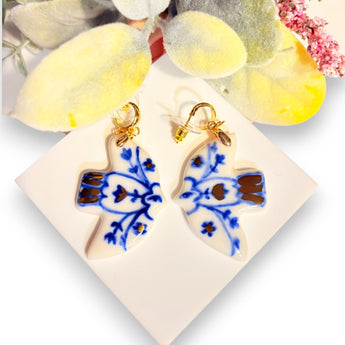 Handmade Porcelain Earrings featuring an elegant bird design with blue floral patterns, showcasing artisanal craftsmanship by BitaJewells.