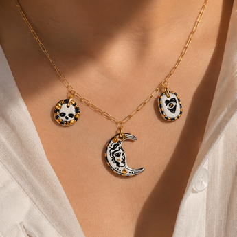 Moon eye skull charm necklace close-up on evil eye porcelain charm with 22K gold lustre