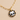 Close-up of hand-painted porcelain skull charm with 22K gold lustre border