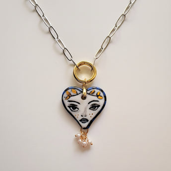 Hand-painted porcelain muse heart pendant necklace, close up of face motif and gold leaf crown