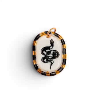 Hand-painted porcelain snake pendant with black and gold checkered border, 22K gold lustre accents
