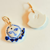 Close-up view of the Midnight Moonface hand-painted porcelain earrings by BitaJewells, highlighting intricate cobalt blue detailing and gold accents. These lightweight handmade ceramic earrings are perfect for anyone who appreciates artisan jewelry, making them a wonderful gift for her or a valentine gift. Their unique design ensures they stand out as a stylish accessory for everyday wear.