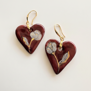 Hand-painted burgundy porcelain heart earrings with white cotton flower motif and 22K gold lustre