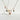 Porcelain charm necklace with clock and bow detail