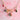 Whimsical porcelain charm necklace on pink backdrop