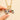 Necklace laid flat showing the gold paperclip chain, lobster claw clasp, and carabiner charm connector